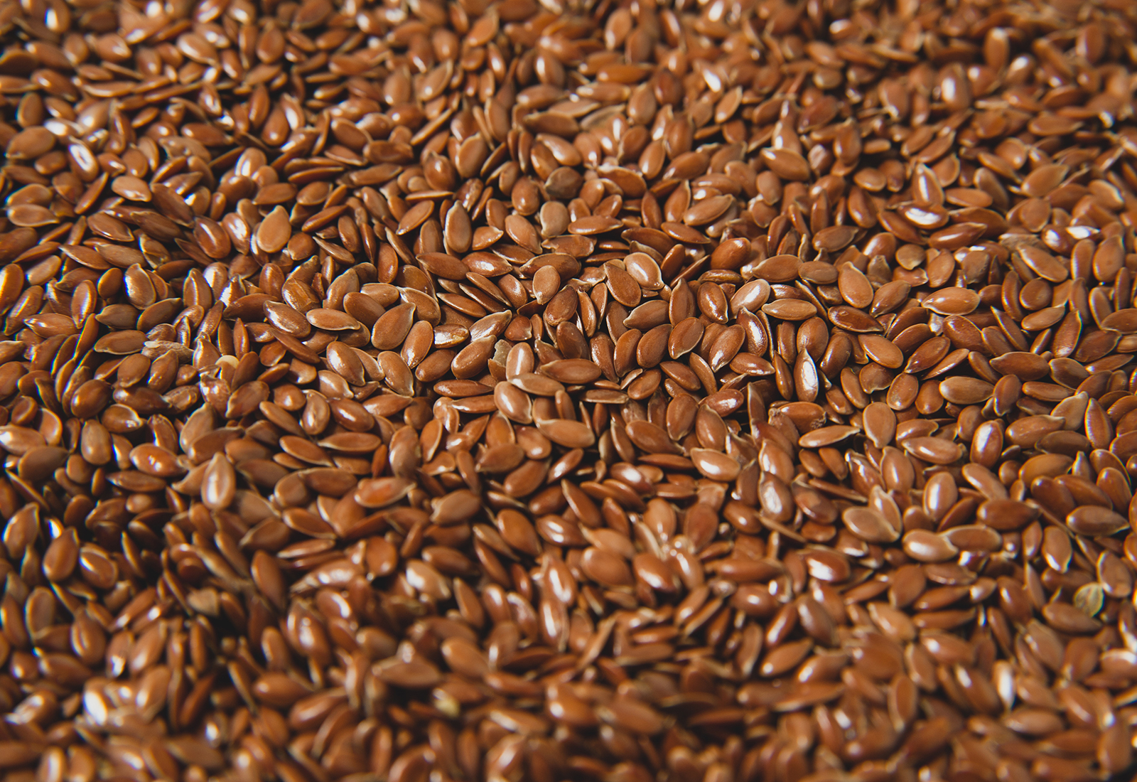 Flax seeds background - healthy food. Superfood for longevity. Macro photo.